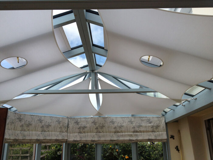 Conservatory shade sails with cut outs for operation